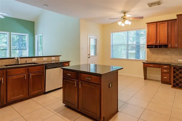 a kitchen with stainless steel appliances granite countertop a sink and a stove