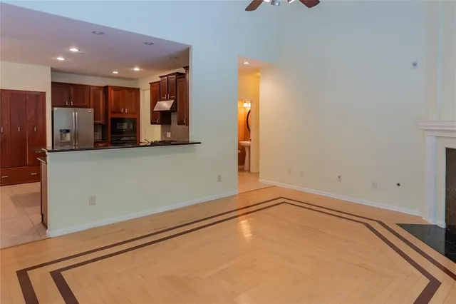 a view of a kitchen with a refrigerator and a stove top oven