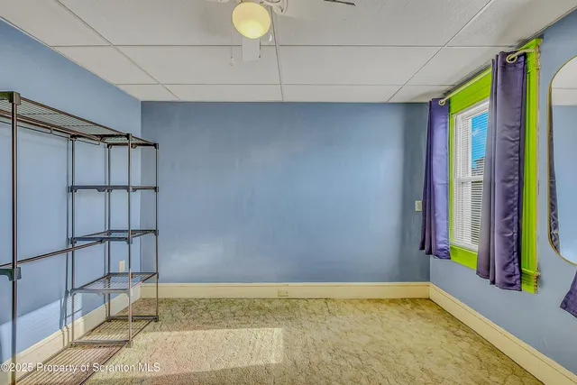 a view of a room with furniture and window