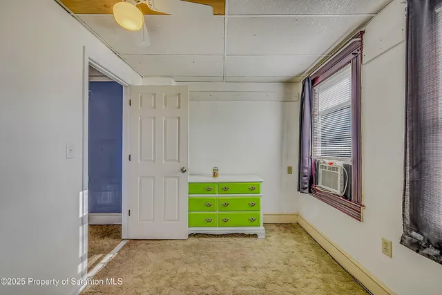 a view of a room with gym equipment and a window