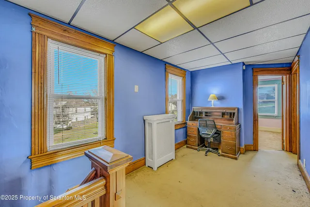 a swimming pool with yard and car parked in front of it