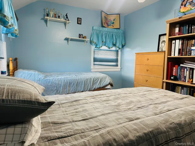a bedroom with a bed and a book shelf