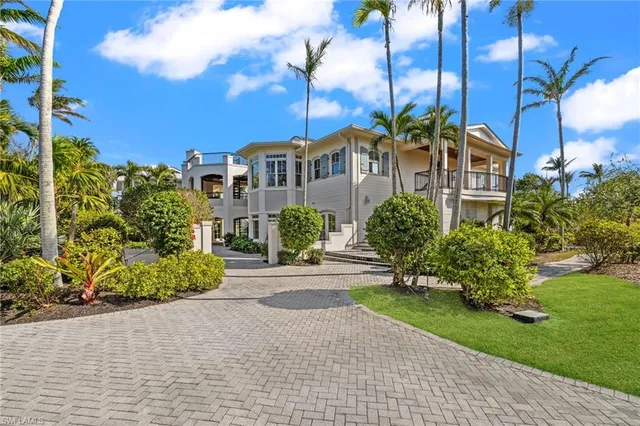 a living room with furniture and large windows