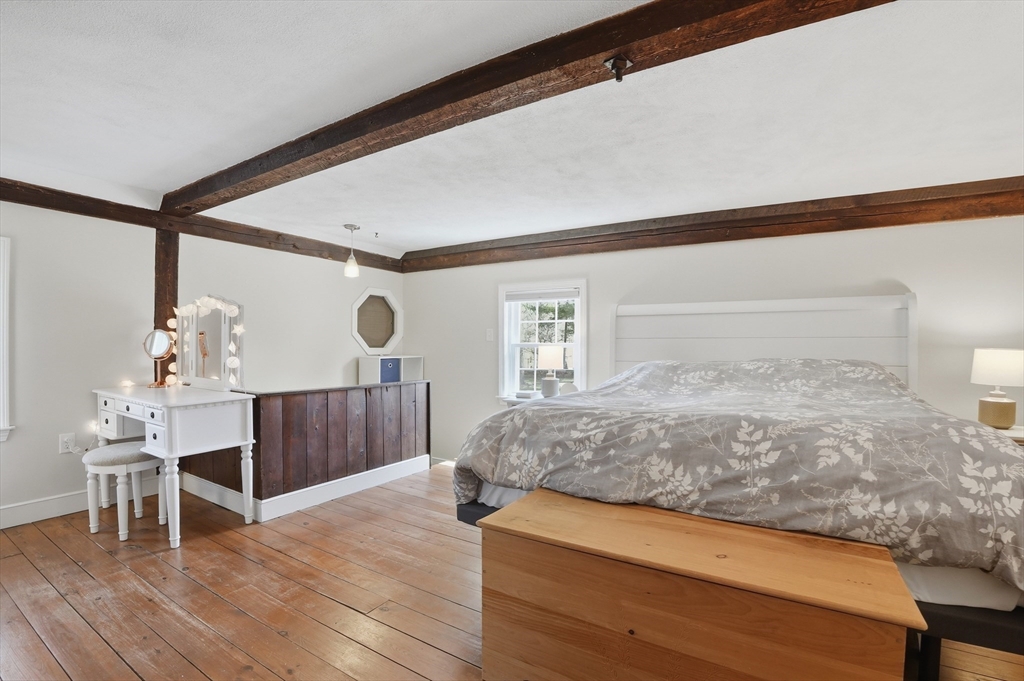 61 Main Street Hanover, MA 02339 - Photo 20 of 38 a bedroom with a bed and a table in it
