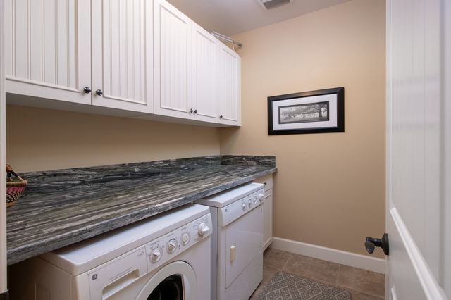 a living room with furniture and flowers