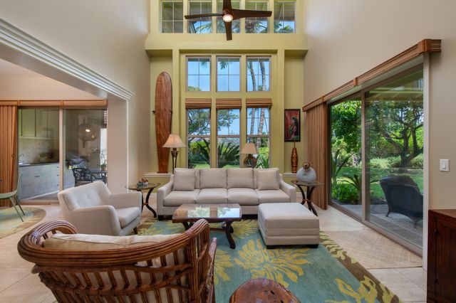 a view of a patio with couches chairs and a yard