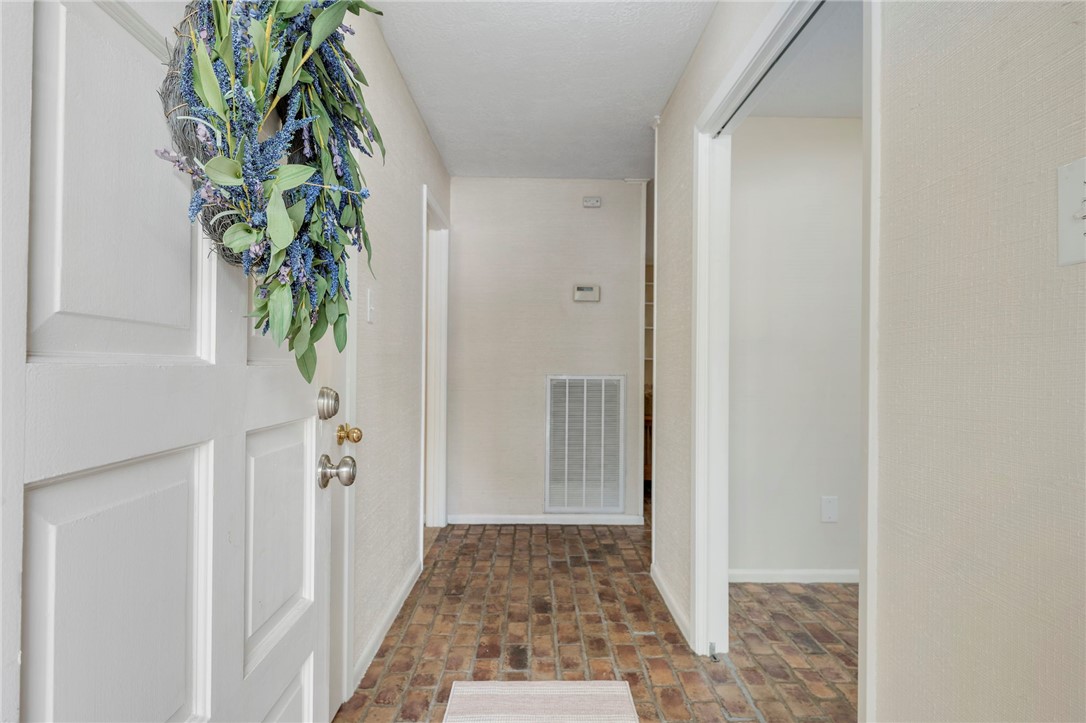 2810 Hillside Drive Bryan, TX 77802 - Photo 2 of 22 a view of a hallway with paintings on the wall