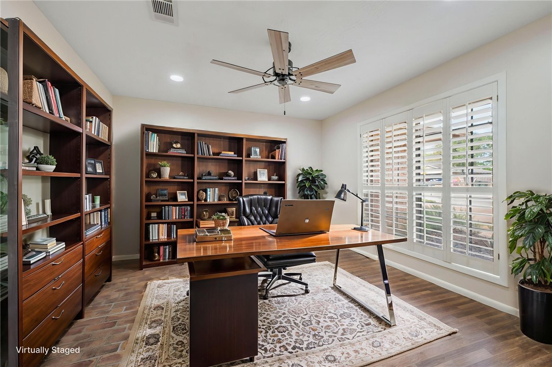 2810 Hillside Drive Bryan, TX 77802 - Photo 3 of 22 a view of a workspace with furniture and a book shelf