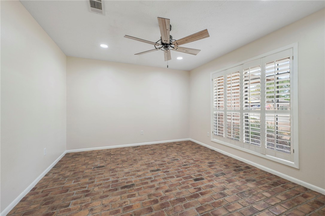 2810 Hillside Drive Bryan, TX 77802 - Photo 4 of 22 an empty room with windows and fan
