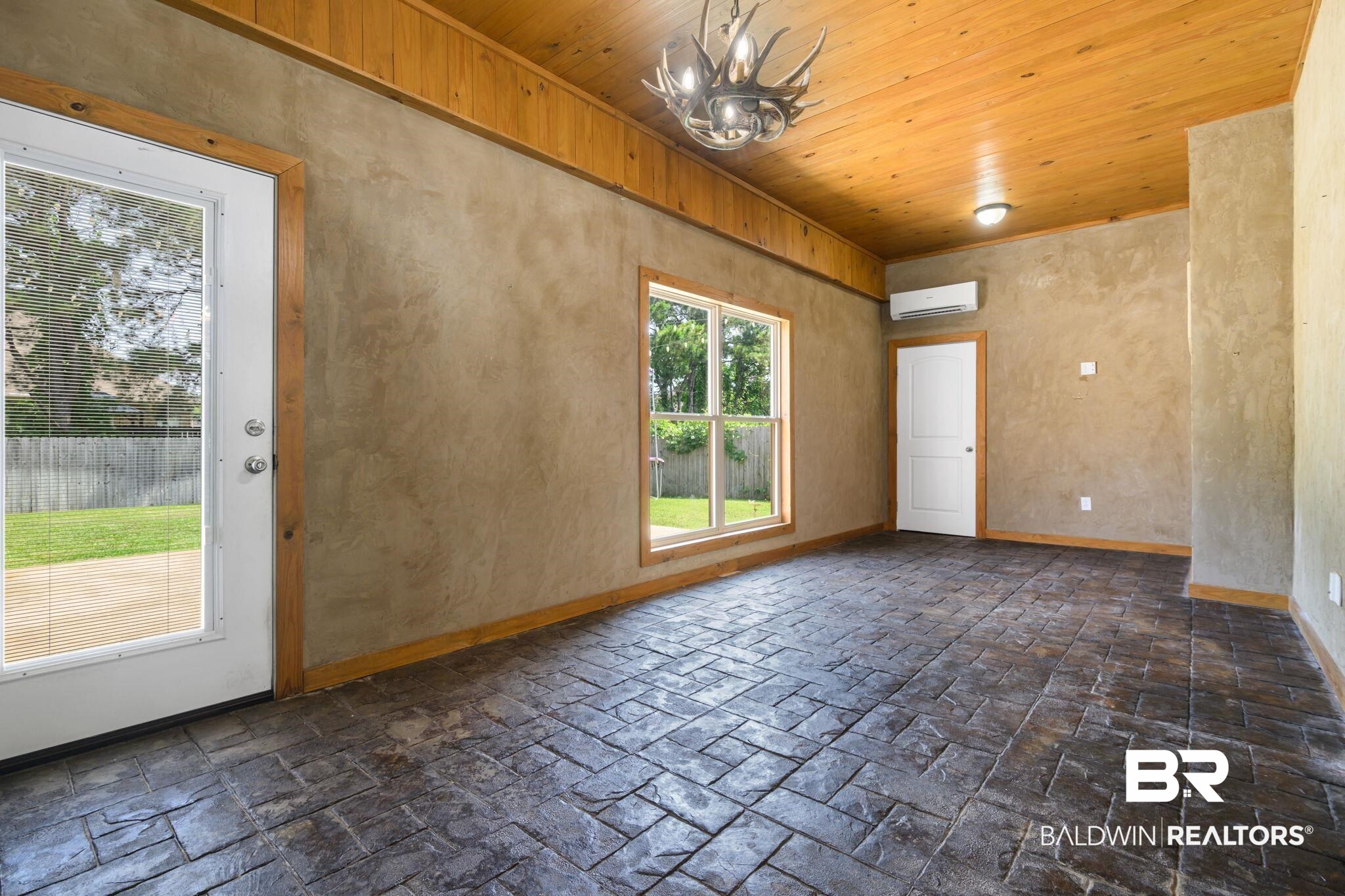 9730 Harmony Ridge Circle West Semmes, AL 36575 - Photo 30 of 38 Unfurnished room featuring a wall mounted air conditioner, a chandelier, baseboards, and wood ceiling
