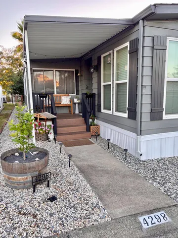 a front view of a house with garden and patio