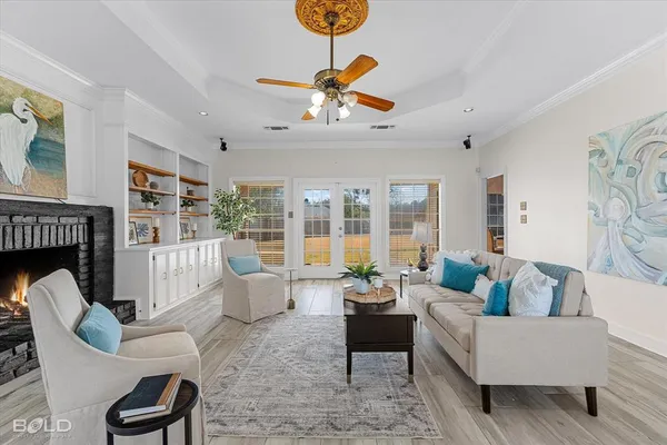 a living room with fireplace furniture and a large window