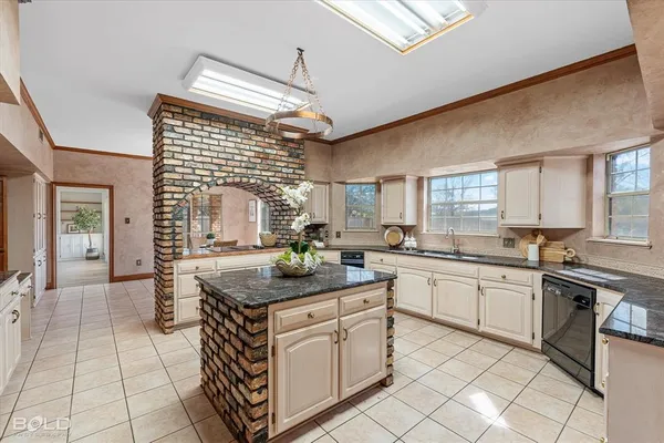 a kitchen with stainless steel appliances granite countertop a sink and cabinets
