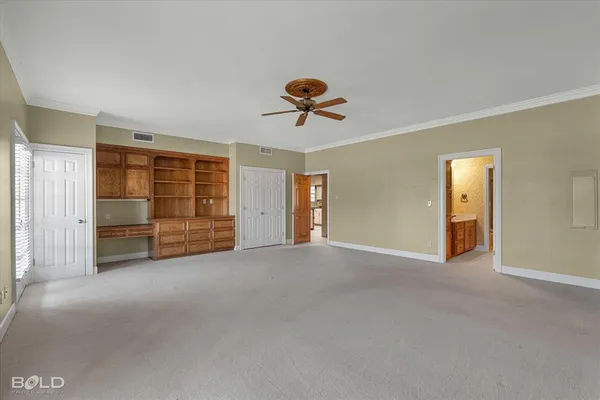 a view of a room with cabinet and a ceiling fan