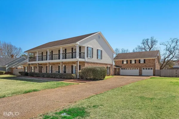 a view of house with yard and green space