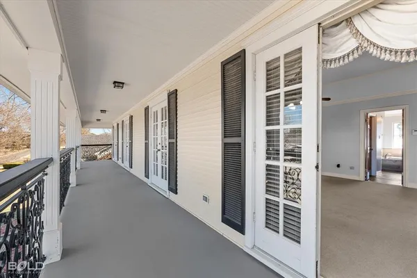 a view of a hallway with windows and stairs