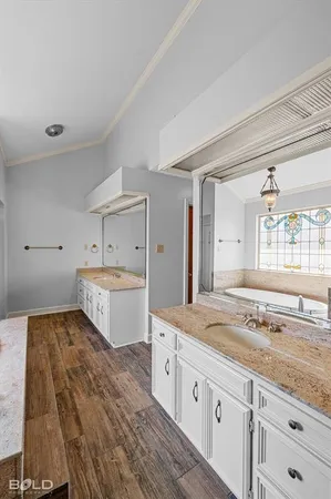 a spacious bathroom with a granite countertop sink mirror bathtub and toilet