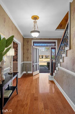 a view of an entryway with dining room and wooden floor