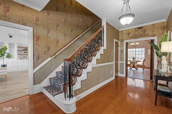 a view of entryway and hall with wooden floor