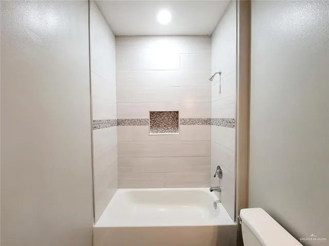 a bathroom with a bathtub and shower