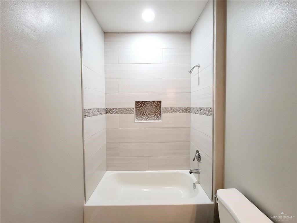1904 Davenport Street, Unit 1 Weslaco, TX 78596 - Photo 14 of 20 a bathroom with a bathtub and shower