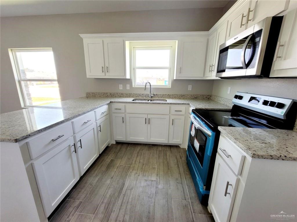 1904 Davenport Street, Unit 1 Weslaco, TX 78596 - Photo 5 of 20 a kitchen with appliances cabinets a sink and a window