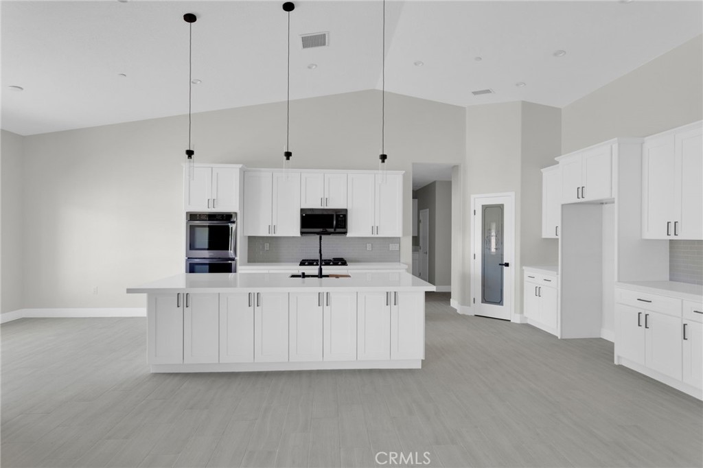 16339 Rimrock Road Apple Valley, CA 92307 - Photo 12 of 50 a large white kitchen with stainless steel appliances