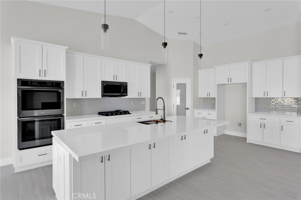 16339 Rimrock Road Apple Valley, CA 92307 - Photo 13 of 50 a kitchen with white cabinets and stainless steel appliances