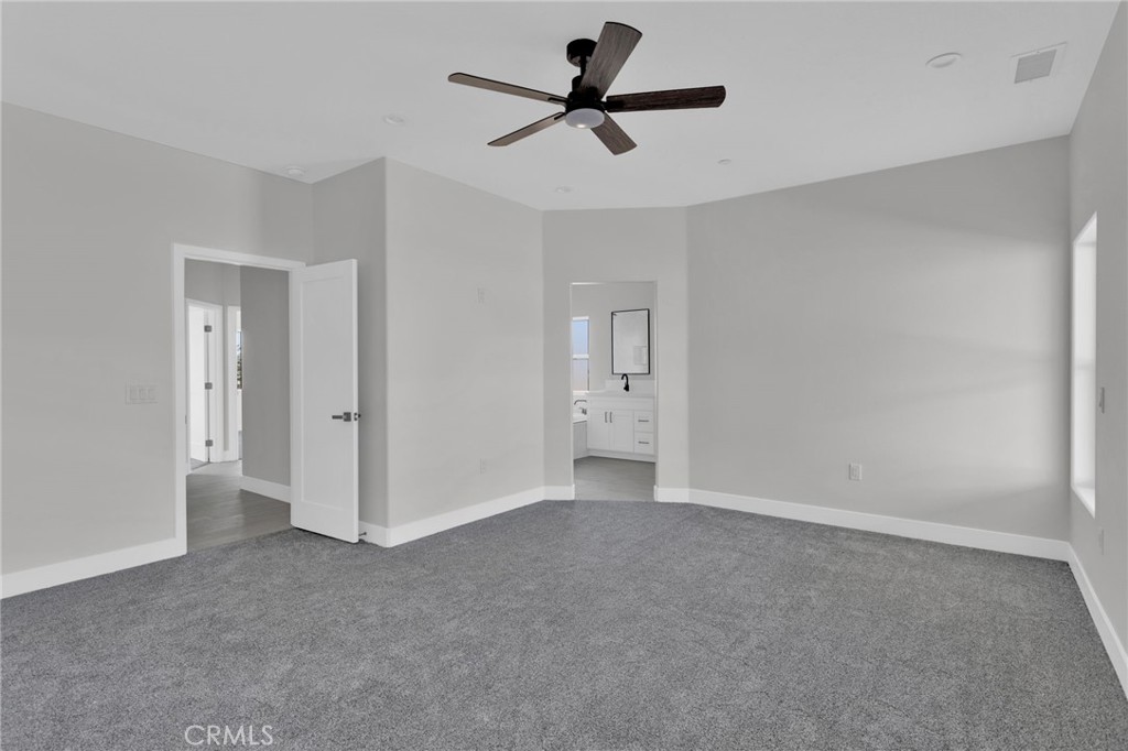 16339 Rimrock Road Apple Valley, CA 92307 - Photo 17 of 50 a view of an empty room and a ceiling fan