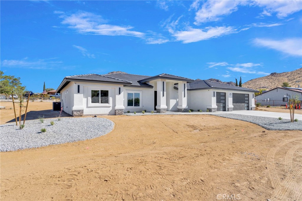 16339 Rimrock Road Apple Valley, CA 92307 - Photo 2 of 50 a house with trees in the background