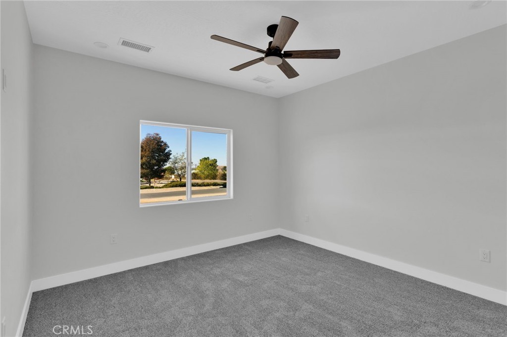 16339 Rimrock Road Apple Valley, CA 92307 - Photo 23 of 50 a view of a livingroom with a window and a ceiling fan