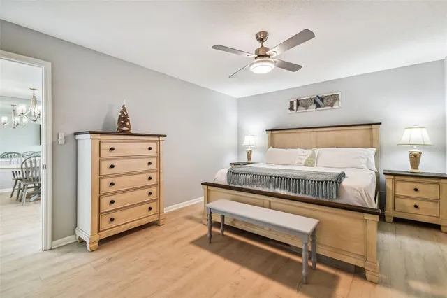 a en suite bathroom with a granite countertop sink and white cabinets