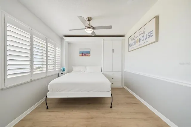 a bedroom with a bed and a large window