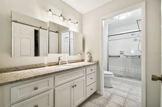 a bathroom with a glass shower door