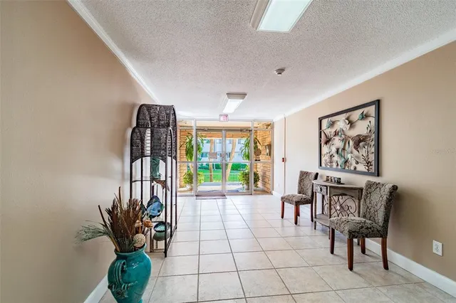 a living room with a couch and a kitchen