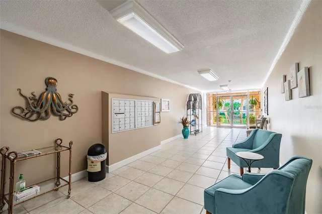 a swimming pool with outdoor seating and a palm tree