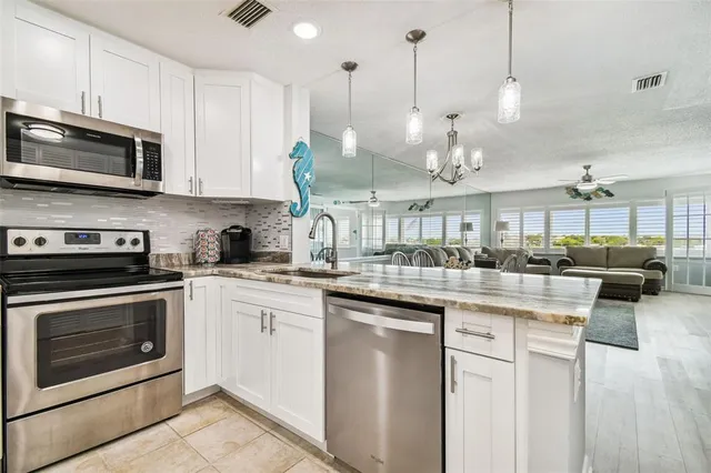 a kitchen with a refrigerator sink and microwave