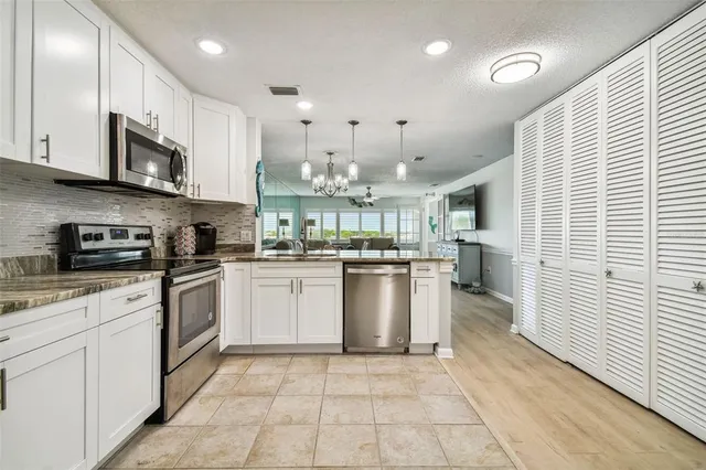 a utility room with cabinets washer and dryer