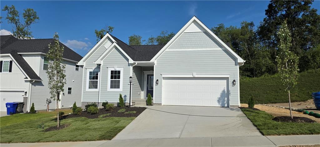 a view of a white house next to a yard with big trees