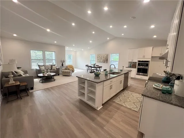 a large white kitchen with a large window