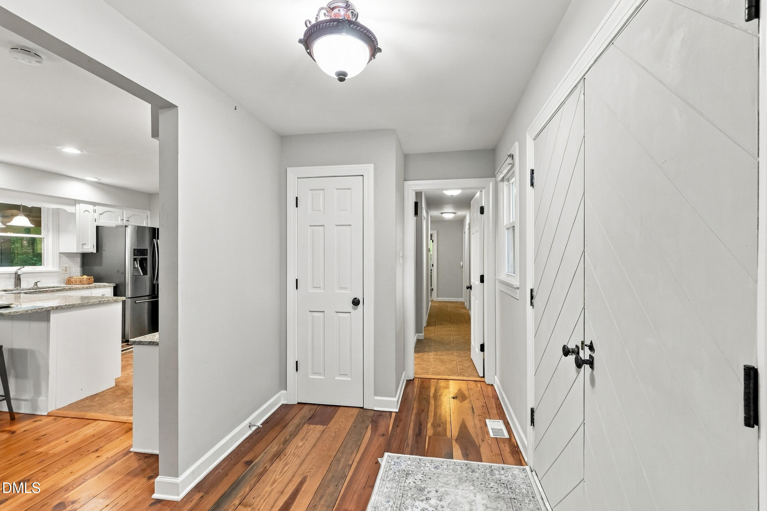 2329 Win Road Garner, NC 27529 - Photo 38 of 90 Wood-finish flooring, white paneled doors, and a decorative ceiling light fixture