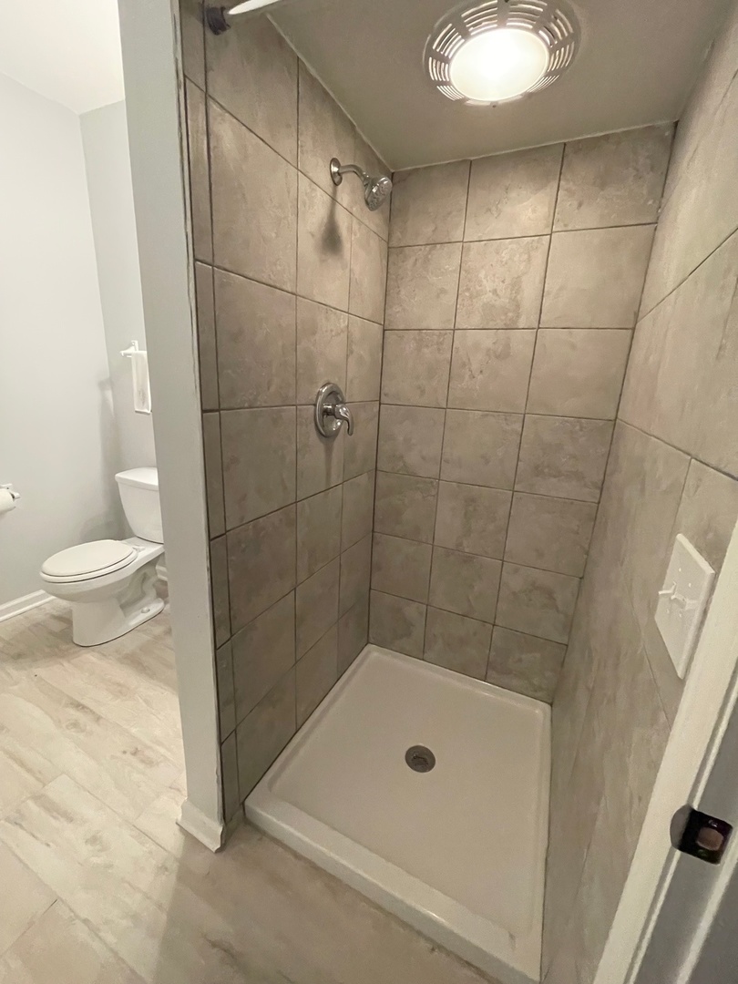 215 Waukegan Road, Unit 2S Lake Bluff, IL 60044 - Photo 13 of 24 a bathroom with a shower and a toilet