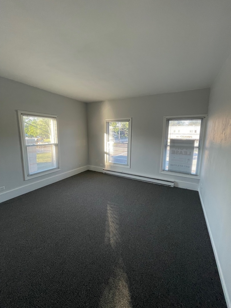 215 Waukegan Road, Unit 2S Lake Bluff, IL 60044 - Photo 15 of 24 a view of room and hall with wooden floor