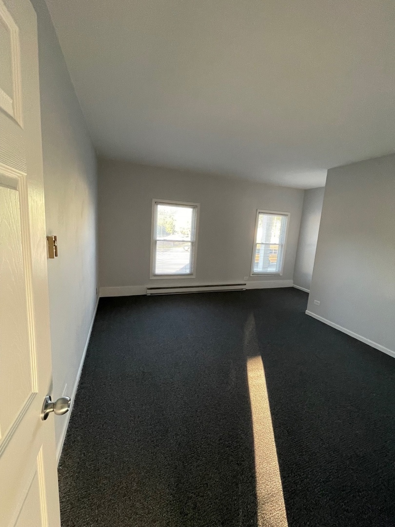 215 Waukegan Road, Unit 2S Lake Bluff, IL 60044 - Photo 18 of 24 wooden floor in an empty room with a window