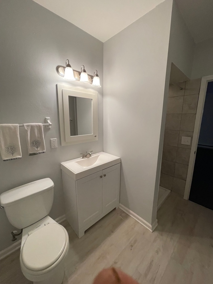 215 Waukegan Road, Unit 2S Lake Bluff, IL 60044 - Photo 10 of 24 a bathroom with a toilet sink and mirror