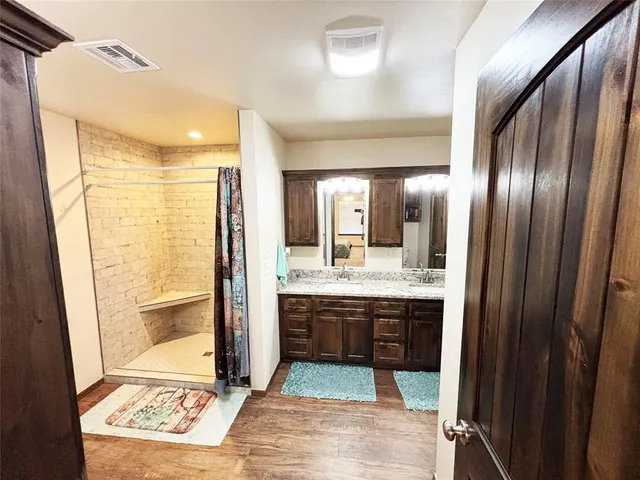 a view of walk in closet with clothes