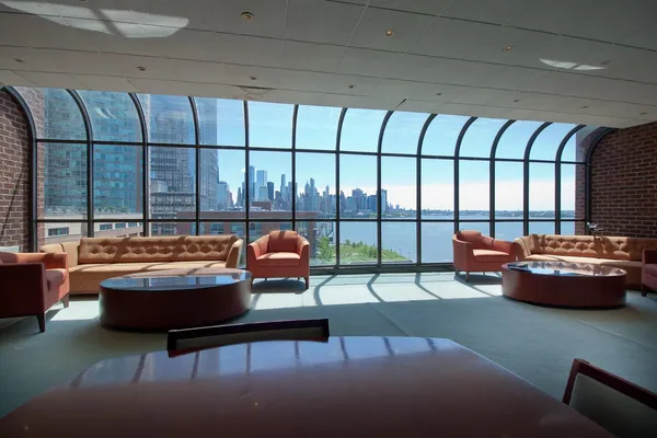 a living room with furniture and a floor to ceiling window