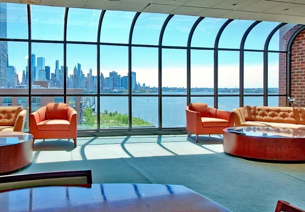 a living room with furniture and a floor to ceiling window