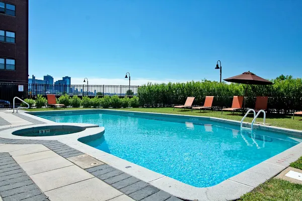 swimming pool view with a seating space