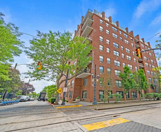 a view of a tall building next to a road